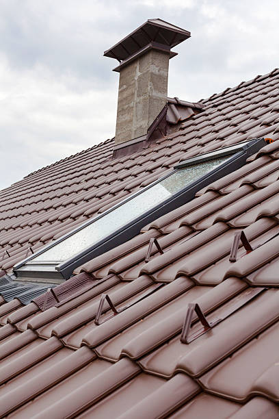 istock New roof with skylight, natural red tile and chimney 513102204