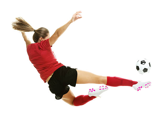 istock Female soccer player kicking the ball 513102447