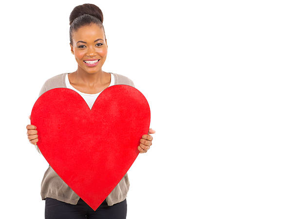 istock african girl showing red heart 513104571