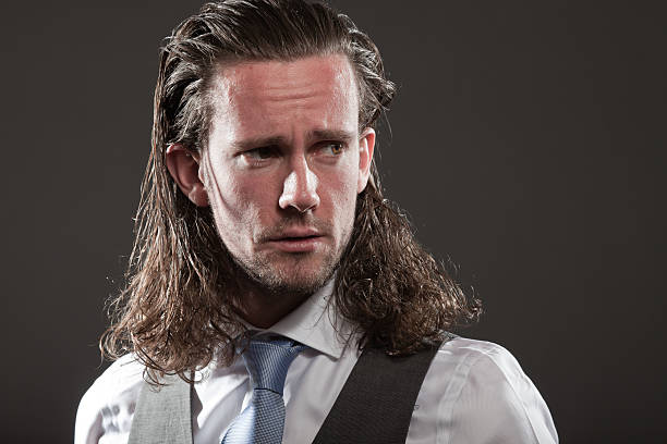 istock Young man long hair expressive face wearing suit and tie. 513104959