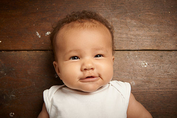 istock Smiling baby girl on floor 513105155