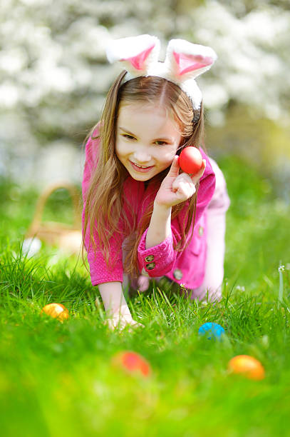 istock Adorable little girl hunting for easter egg on Easter day 513105336