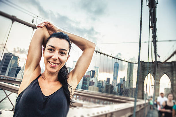 istock Woman doing stretching on Brooklyn Bridge 513106477