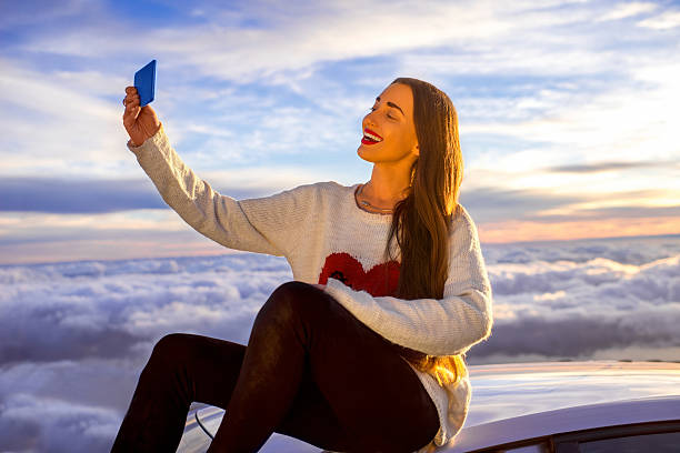 istock Woman enjoying beautiful cloudscape 513107204
