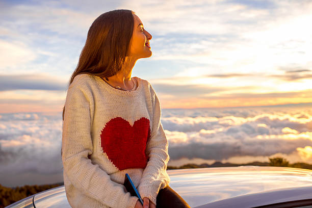 istock Woman enjoying beautiful cloudscape 513108078