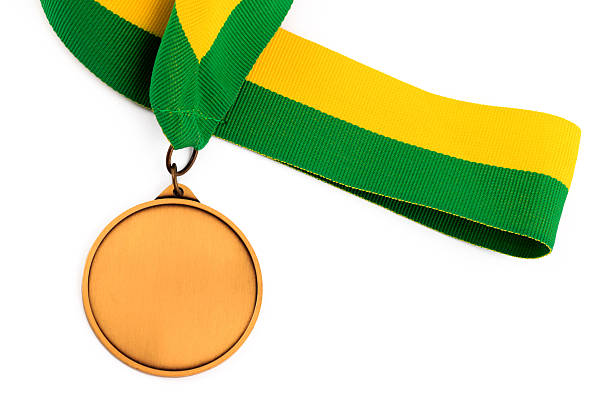 istock Gold medal on yellow green ribbon 513108412