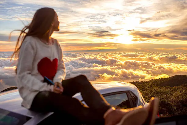 Photo of Woman enjoying beautiful cloudscape