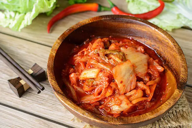 kimchi with Chopsticks on wooden table, korean traditional food
