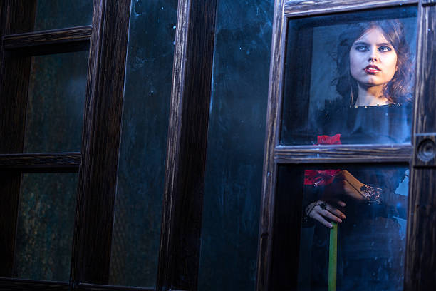 istock Pensive Young Woman Standing Behind Window 513110104