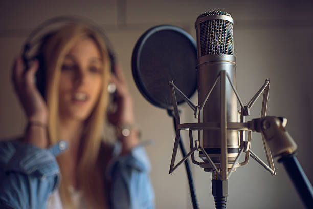 istock Microphone in recording studio with singer in the background. 513110442