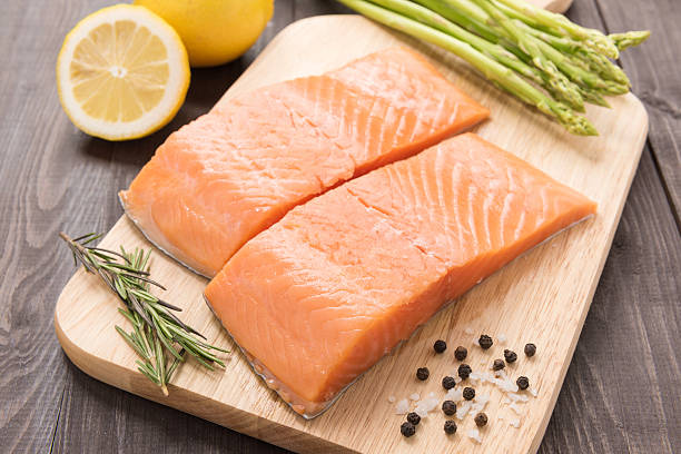 istock Fresh salmon fillet with spice on wooden table 513116200