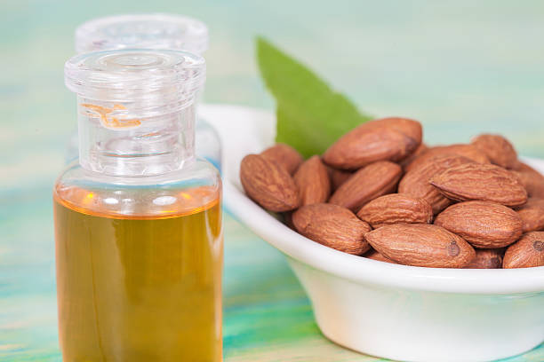 istock Almonds on wood and oil bottle 513117840