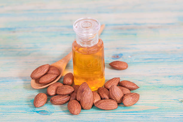 istock Almonds on wood and oil bottle 513118164