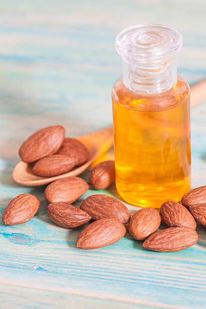 istock Almonds on wood and oil bottle 513118414