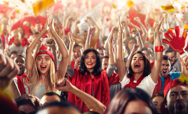 istock Sport fans: Three girls put hands in the air 513120278