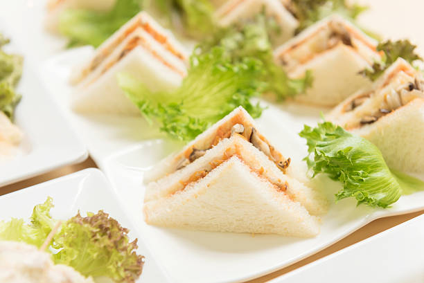 Freshly made of mixed sandwich triangles on wooden background.