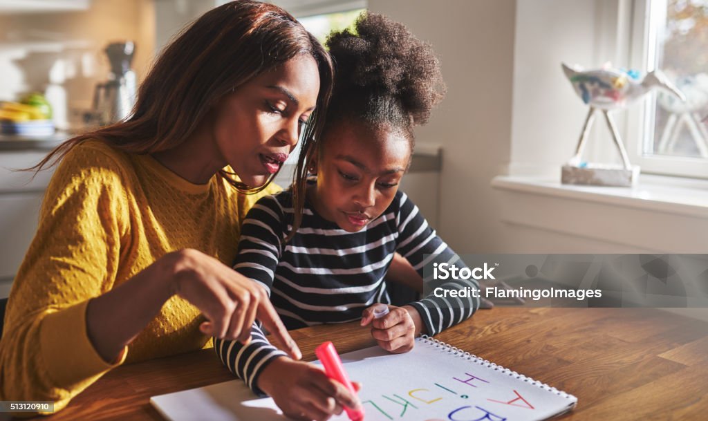 Little black girl learning to read Little black girl learning to read learning the alphabet Child Stock Photo