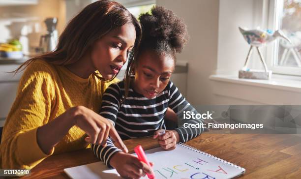 Little Black Girl Learning To Read Stock Photo - Download Image Now - Child, Parent, Homework