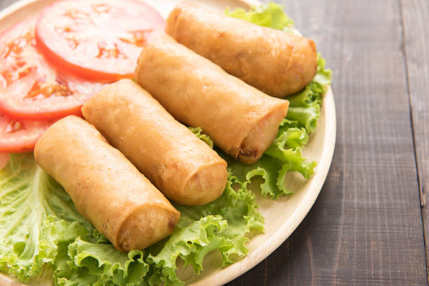 istock Fried Chinese traditional spring rolls on wooden table 513121040