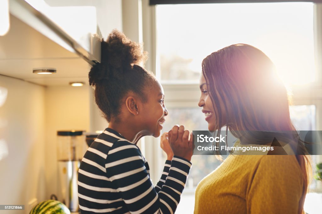 Black woman and little daughter smiling Black woman and little daughter smiling and showing love to each other Mother Stock Photo