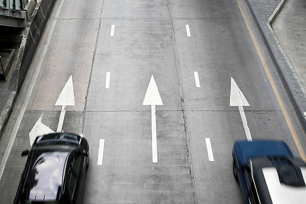 istock Two cars on street with arrow direction. 513124702