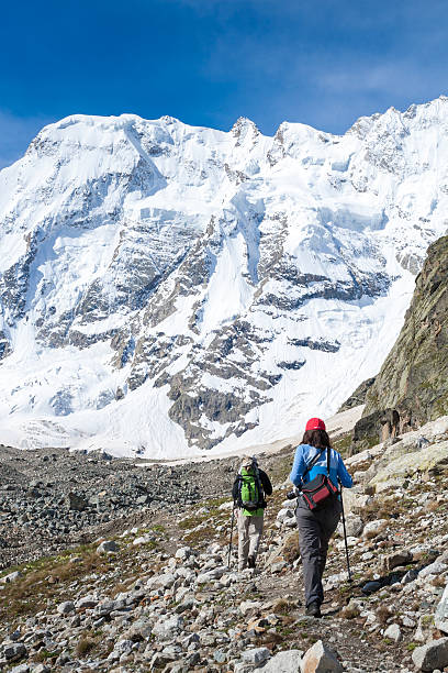 istock Hikiers are approaching wall covered with snow in Caucasus mount 513125130