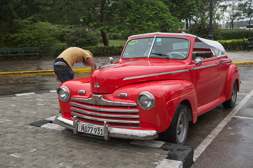 havana, Сuba - January 17, 2016: People are washing old historical american car at street of havana cuba