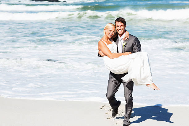 istock Loving Groom Carrying Bride While Walking On Beach 513126824