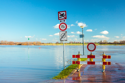 Flooded road in front of the Dutch river IJssel in the province of Gelderland