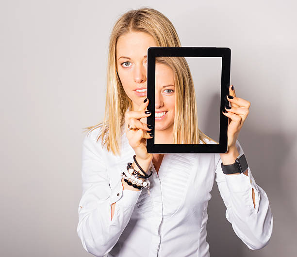 istock Woman standing with portable device in her hands 513129228