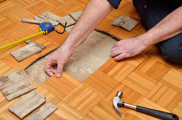 istock Man Removing Damaged Parquet 513130612