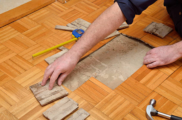 istock Worker Repairing Damaged Floor 513131088