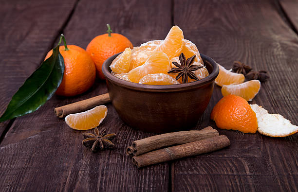 istock Tangerines with cinnamon stick and anisetree on old wooden table 513131552