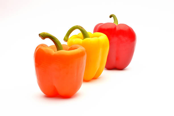 istock Red, orange and yellow capsicum on a white background 513133217