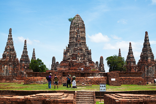 Ayutthaya, Thailand - July 2, 2013: Capture of a group of male tourists in temple Wat Chai Watthanaram in Ayutthaya.