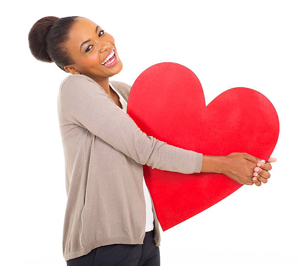istock afro american girl holding heart shape 513134487