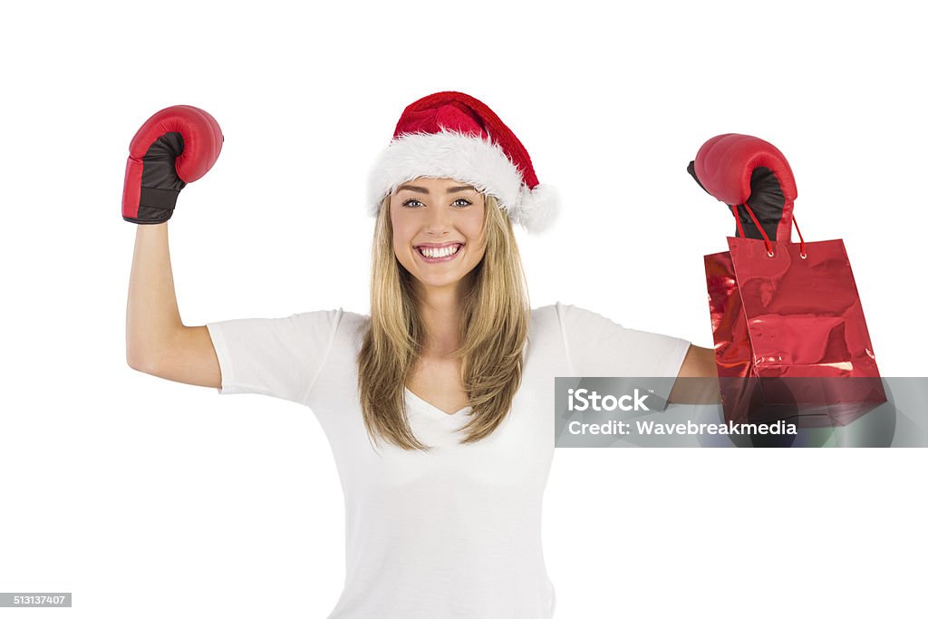 Festive blonde punching with boxing gloves Festive blonde punching with boxing gloves on white background 18-19 Years Stock Photo