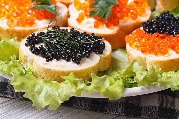 istock Sandwiches with red and black caviar on lettuce 513137849