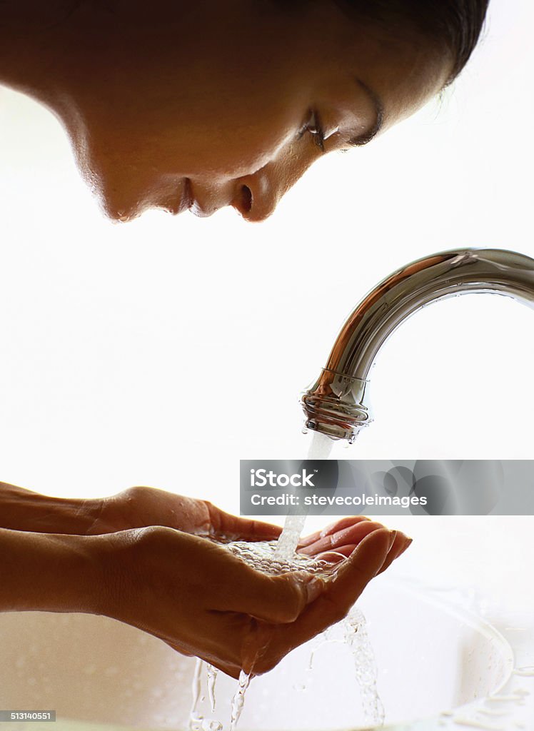 Washing Face Woman splashing water on her face. Beauty Stock Photo
