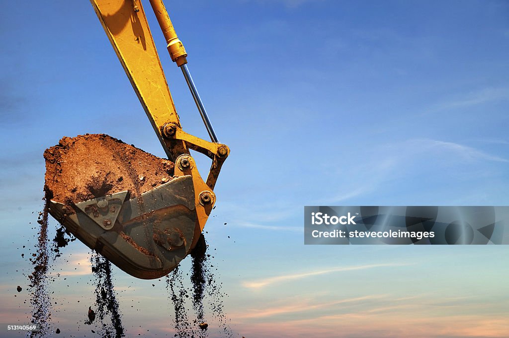 Backhoe Excavator lifting dirt. Backhoe Stock Photo