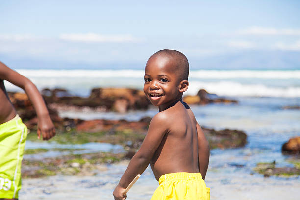 istock African boy fishing in a tidal pool 513140745