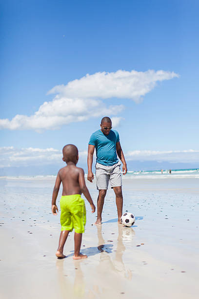 istock African father playing soccer with his son 513140753