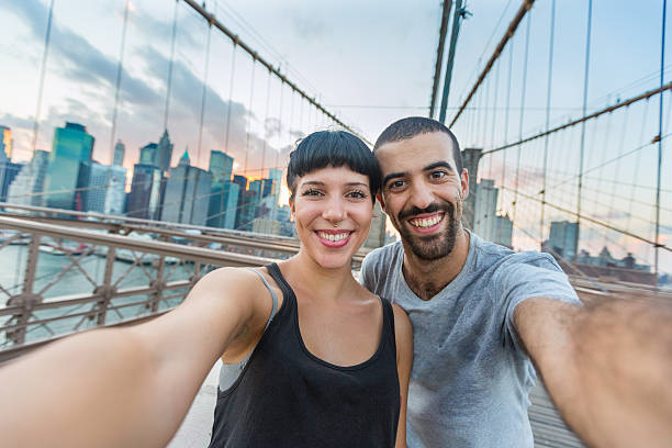 istock Young Couple Taking Selfie on Brooklyn Bridge 513159953