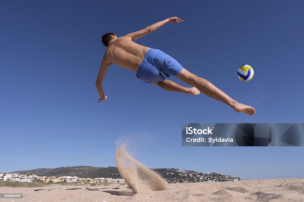 Soccer Young man playing soccer on beach Activity Stock Photo