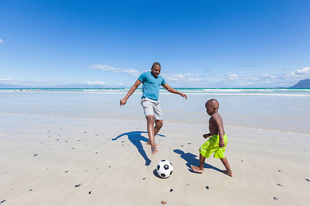 istock African father playing soccer with his son 513162281