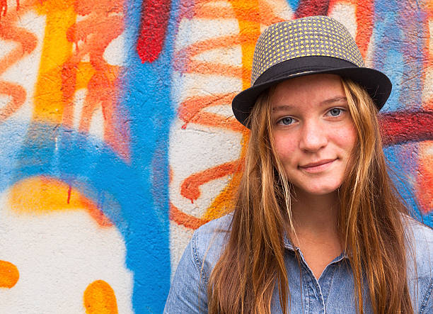 istock Beautiful stylish young girl outdoors, bright colored wall. 513162715