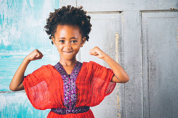 Beautiful young Ethiopian girl in traditional clothing, showing strength Beautiful young Ethiopian girl in traditional clothing, showing strength ethiopian ethnicity photos stock pictures, royalty-free photos & images