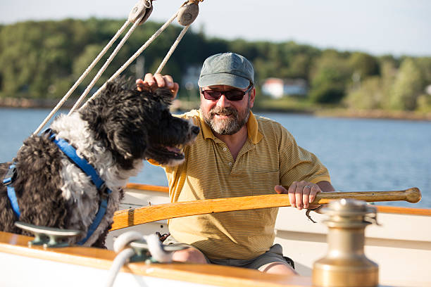 istock Man and his dog on a sailboat 513163997