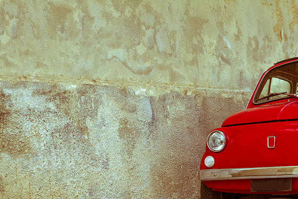 istock Cute Red Vintage Car Against Old Textured Wall, Sicily 513164093