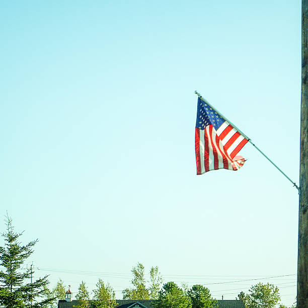 istock us flag waving on the sky 513164423